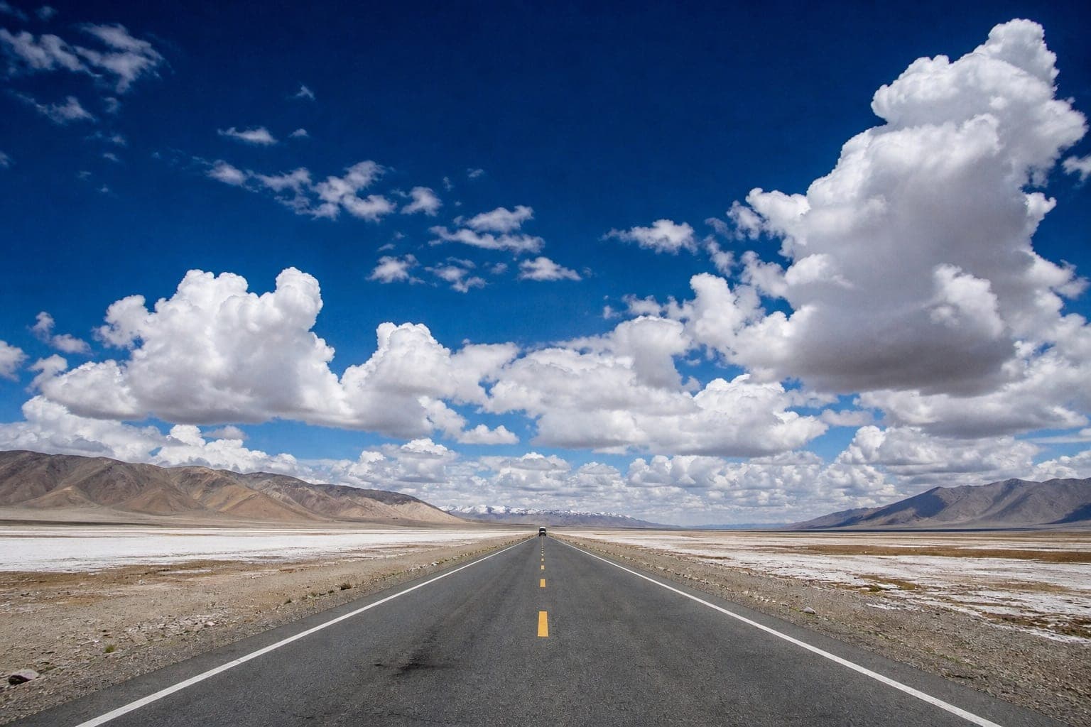 An empty road crossing the western Tibetan plateau