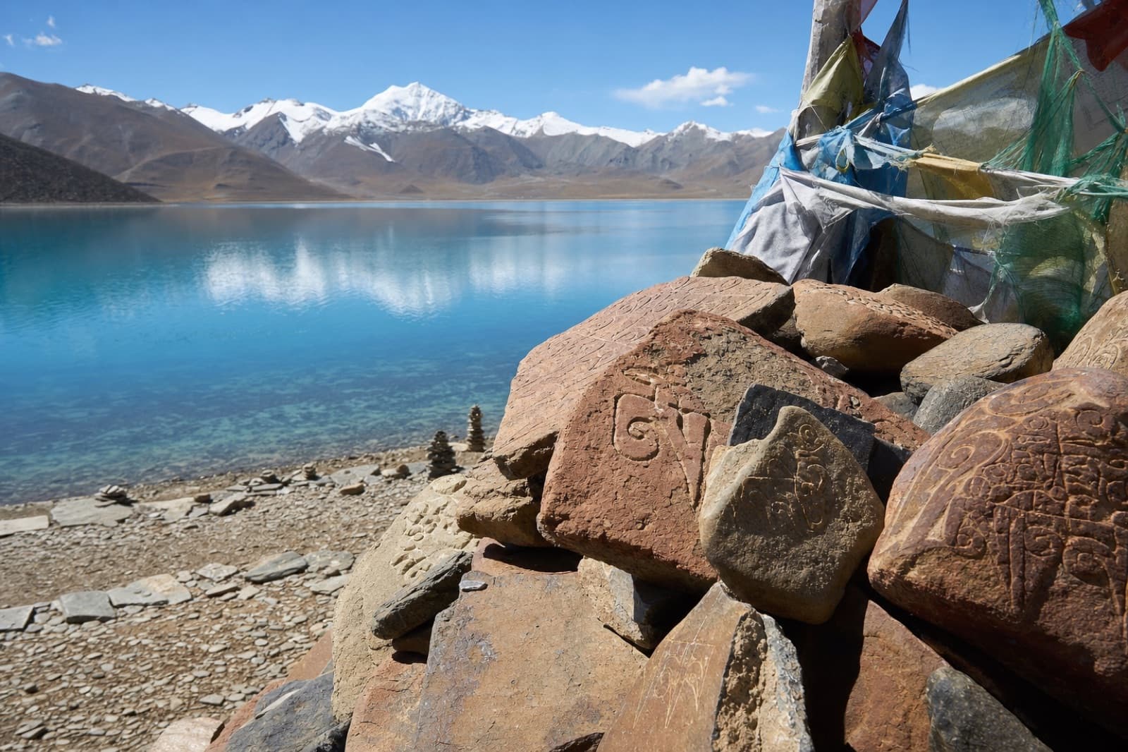 A turquoise high-altitude lake ringed by mountains
